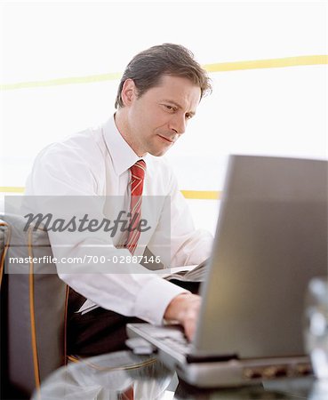 Businessman using Laptop in Airport