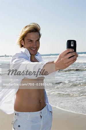 Man Taking Picture with Camera Phone, Ibiza, Spain