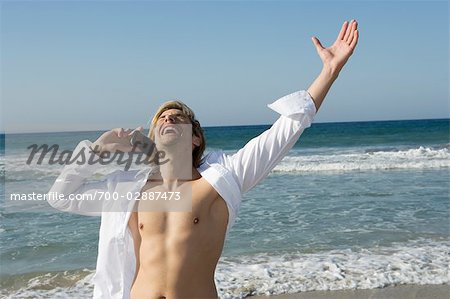 Man using Cell Phone at Beach, Ibiza, Spain