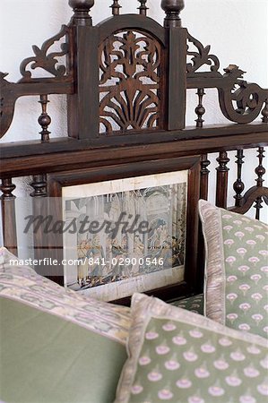 Detail of colonial style bed, with inset of 19th century print of courtly scene, residential home, Dehra Dun, Himalayan foot hills, Uttar Pradesh state, India, Asia