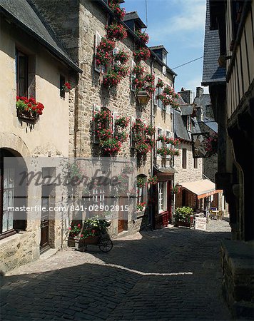 Pots and windowboxes of geraniums on houses on the Rue de Jerzual in Dinan, Brittany, France, Europe