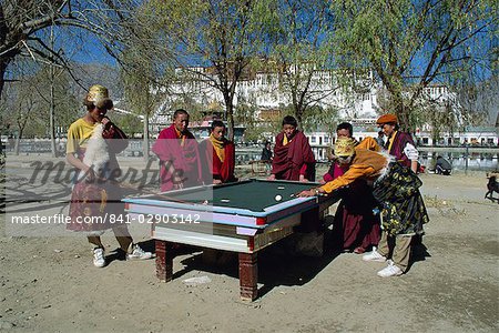 Locals playing pool with Potala Palace in background, Lhasa, Tibet, China, Asia