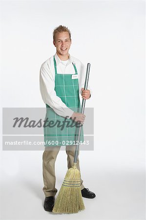 Portrait of Grocery Clerk Holding a Broom