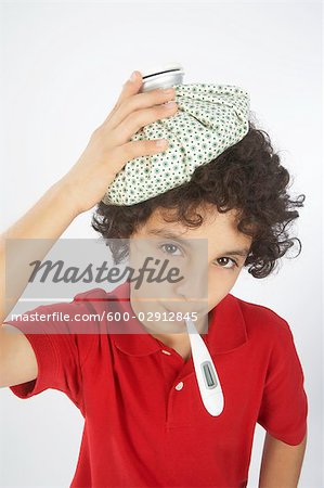 Boy With a Thermometer in His Mouth and an Ice Pack on His Head