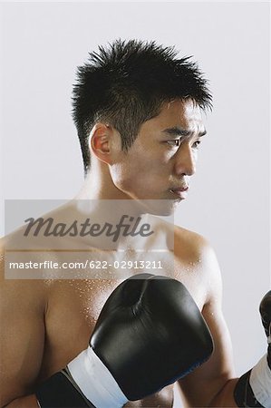 Japanese boxer wearing gloves and sweating