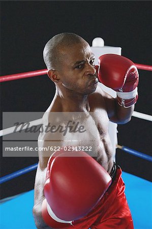 African boxer wearing red Boxing gloves ready to punch