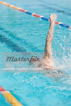 Young Australian swimmer doing backstroke