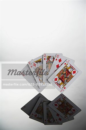 Poker,hand showing reflection of royal flush in diamond