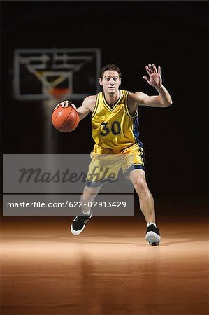 Basketball player dribbling ball