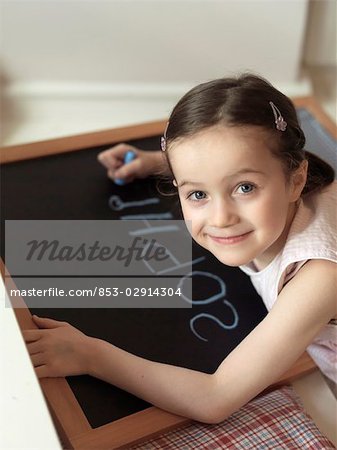 girl writing on a blackboard