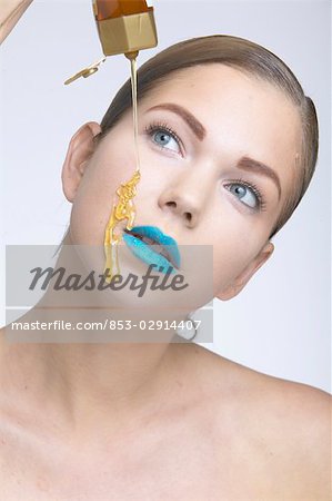 Woman with blue lipstick and honey