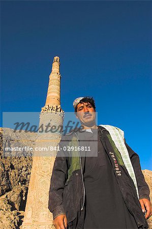 Afghani man in front of 12th century Minaret of Jam, UNESCO World Heritage Site, Ghor (Ghur, Ghowr) Province, Afghanistan, Asia