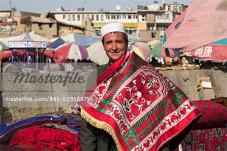 Man selling rugs on banks of Kabul river, Central Kabul, Afghanistan, Asia