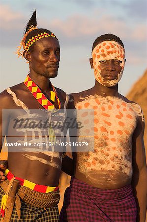 Karo men with body painting, made from mixing animal pigments with clay, at dancing performance, Kolcho village, Lower Omo valley, Ethiopia, Africa