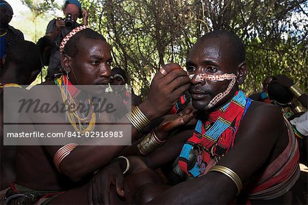 Face painting with a mixture of clay, oils and plant pigments, Hamer Jumping of the Bulls initiation ceremony, Turmi, Lower Omo valley, Ethiopia, Africa