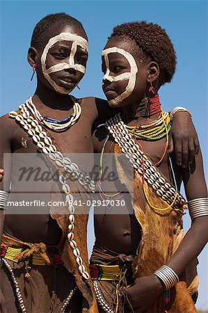 Two Hamer (Hamar) girls wearing traditional goat skin dress decorated with cowie shells, Dombo Village, Turmi, Lower Omo Valley, Ethiopia, Africa