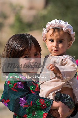 Aimaq girl holding baby, Pal-Kotal-i-Guk, between Chakhcharan and Jam, Afghanistan, Asia