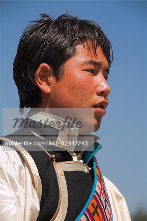 Young Tibetan man in traditional clothes during Lhosar (Tibetan and Sherpa New Year festival), Bodhnath, Bagmati, Kathmandu, Nepal, Asia