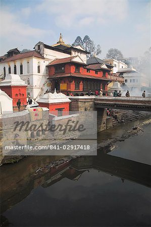 Smoke rising from cremation ceremony on banks of Bagmati River during Shivaratri festival, Pashupatinath Temple, UNESCO World Heritage Site, Kathmandu, Nepal, Asia