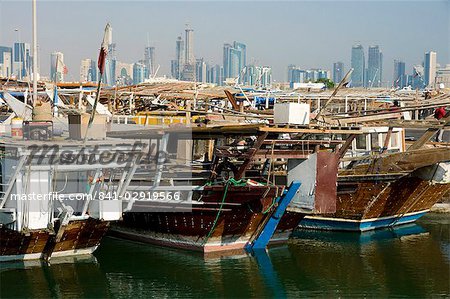 Dhows in Doha Bay and city skyline, Doha, Qatar, Middle East