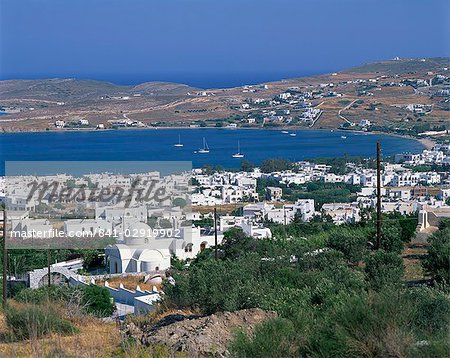 White church and houses overlooking a bay on Paros, Cyclades Islands, Greek Islands, Greece, Europe