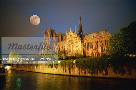 Notre Dame Cathedral at night, with moon rising above, Paris, France, Europe