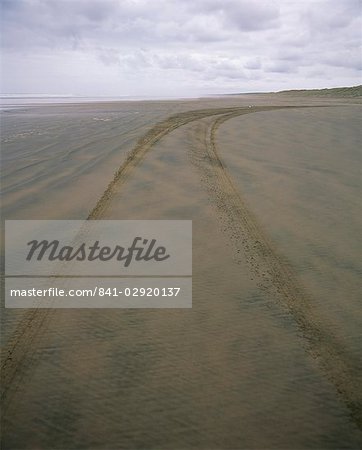 Car tracks along 90 Mile Beach, officially designated a road, in Northland, North Island, New Zealand, Pacific Car tracks along 90 Mile Beach, officially designated a road, in Northland, North Island, New Zealand, Pacific