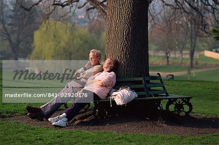 Elderly couple enjoying the spring sunshine, Castle Park, Colchester, Essex, England, United Kingdom, Europe