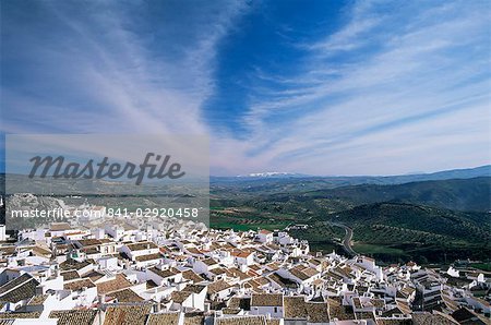 View over village rooftops to distant snow-capped mountains, Olvera, Cadiz area, Andalucia, Spain, Europe