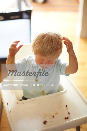 Baby Boy in High Chair, Making a mess With His Food