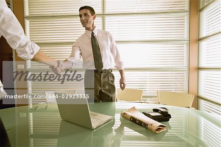Businessman in office greeting businesswoman