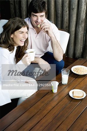 Young couple having breakfast outdoors