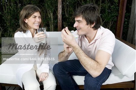 Young couple having breakfast outdoors