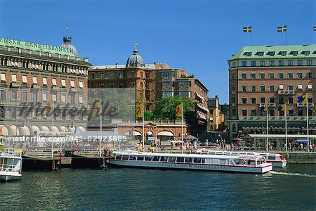 Sightseeing boat and waterfront hotels and cafes in the city centre of Stockholm, Sweden, Scandinavia, Europe