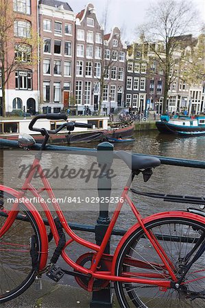 Red bicycle by the Herengracht canal, Amsterdam, Netherlands, Europe