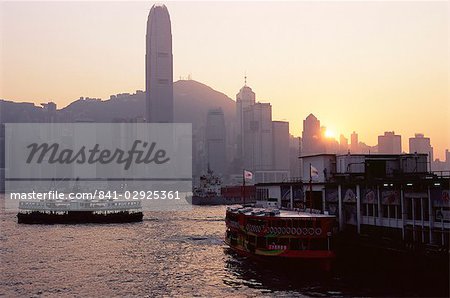 Star Ferry, Victoria Harbour and skyline of Hong Kong Island at sunset, Hong Kong, China, Asia