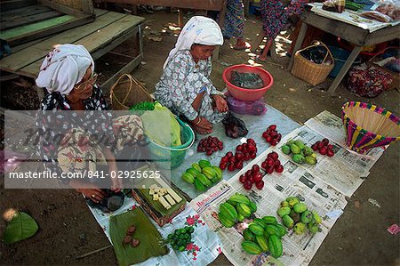 Women selling local produce including star fruit, plums and beeswax at Kota Belud weekly Tamu or market in Sabah, Malaysia, Borneo, Southeast Asia, Asia