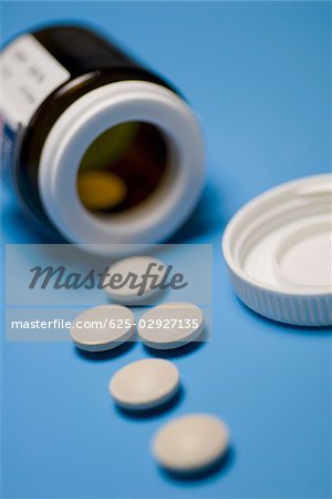 Close-up of pills with a bottle