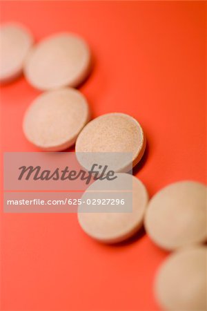 Close-up of pills on a red background