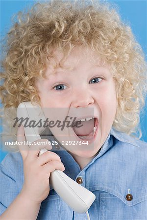 Portrait of a boy shouting on the phone