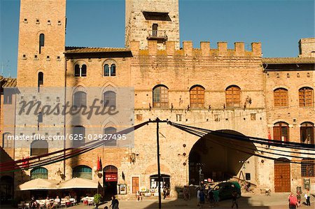 Sidewalk cafe in front of a building, Piazza Duomo, San Gimignano, Siena Province, Tuscany, Italy