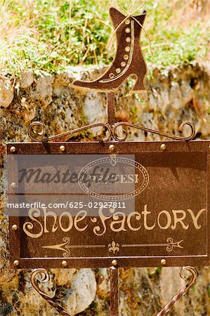 Close-up of an information sign of a shoe factory, Monteriggioni, Siena Province, Tuscany, Italy