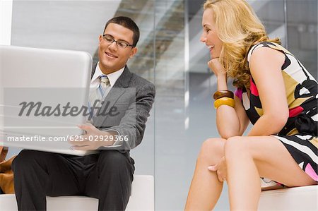 Businessman holding a briefcase with a mature woman sitting beside him