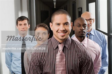 Business executives standing in a corridor