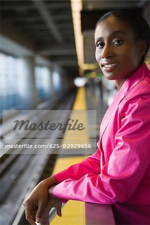 Portrait of a businesswoman standing at a subway station and smiling