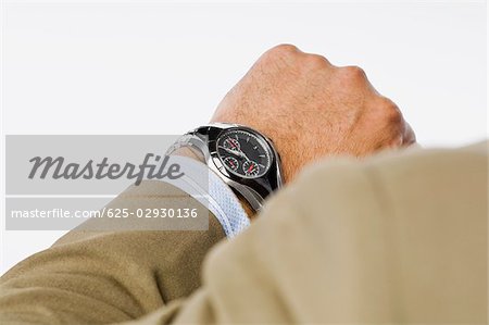 Close-up of a businessman checking the time