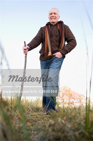 Senior man hiking in a field