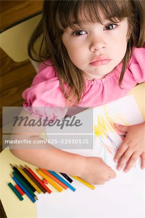 Portrait of a girl drawing on a sheet of paper