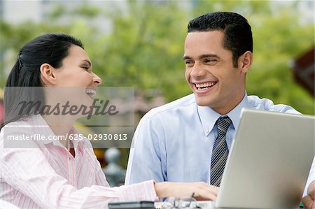 Close-up of a businessman and a businesswoman looking at each other and smiling