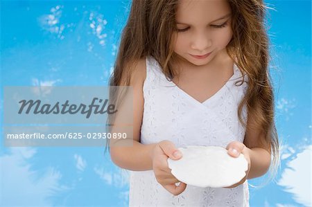 Close-up of a girl holding a seashell